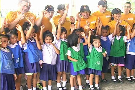 Members of the U.S. Navy join in the fun and games with local children at the Baan Nong Chakngeaw School in Banglamung on Tuesday, Feb. 22.
